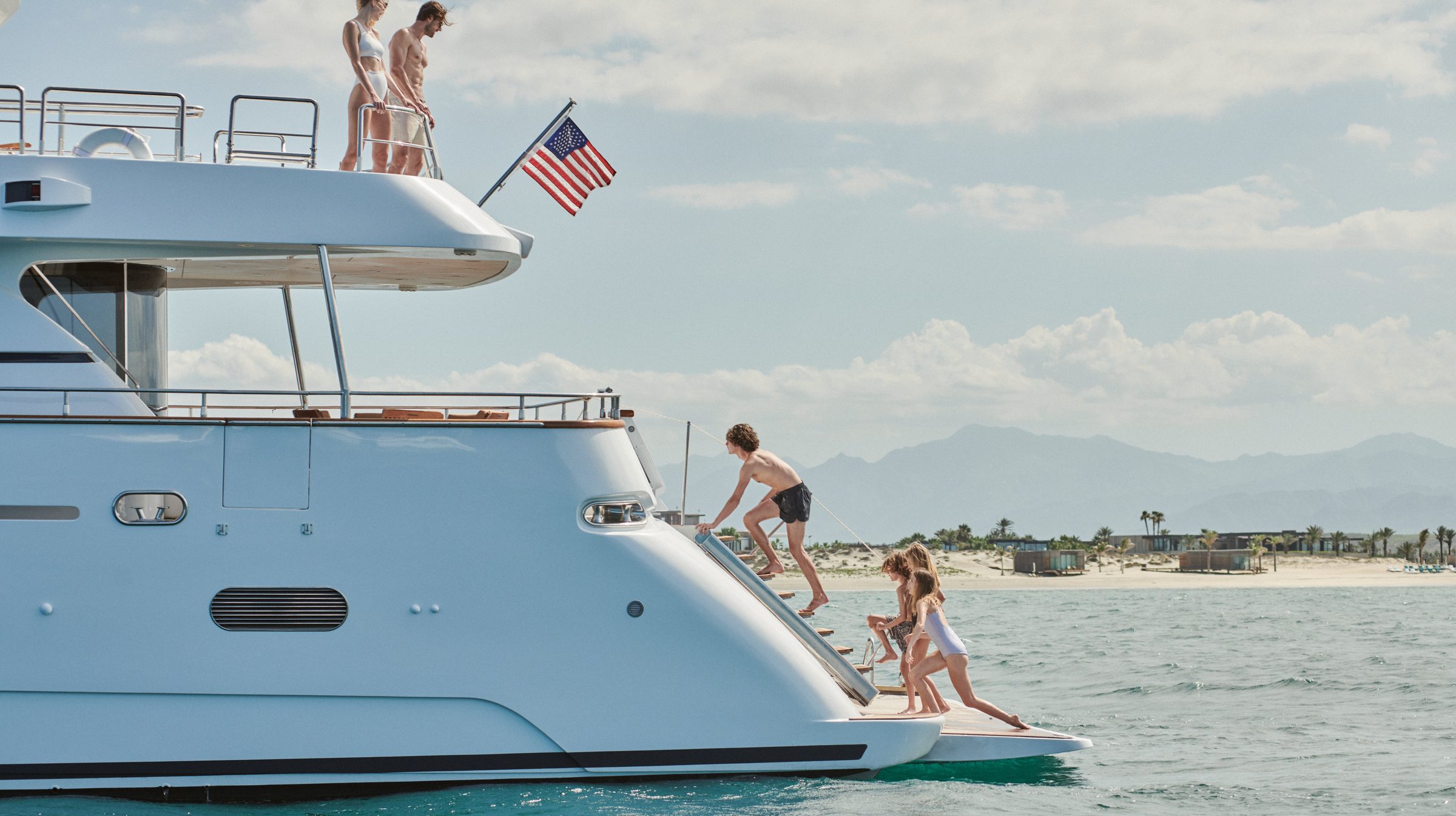 A family swimming from a yacht off Costa Palmas
